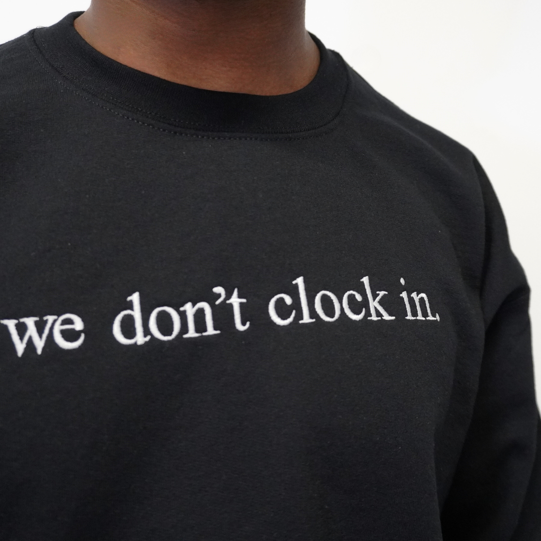 Our "we don't clock in." black crewneck is made from.... This comfortable and stylish crewneck has been crafted for repeat wear and reflects the intersection of timeless fashion and durability. Crafted with care and precision, its minimalist design allows the powerful statement "we don't clock in." to take center stage, making it a conversation starter wherever you go. Wear with pride, knowing that you're not just wearing a garment, but a symbol of independence and self-determination.