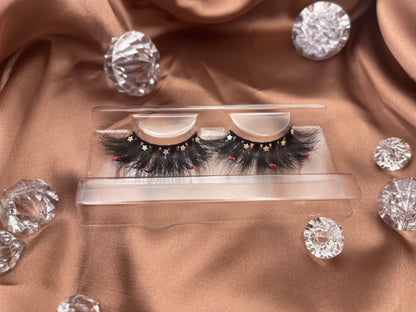 Looking for a lash with a little bling? These Teirrah Seinek Majestic lashes are for you. These 20mm fluffy, voluminous lashes are great with any outfit and will definitely turn heads.    Lash Length: 20mm Full Strip Lashes