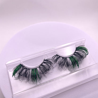 With a hint of green glitter, these 23mm Teirrah Seinek Grandoise luxury lashes are bound to complete your outfit. These lashes add length, volume, and thickness to your lash look, and are undetectable, blending with your natural lash line.  Lash Length: 23mm Full Strip Lashes