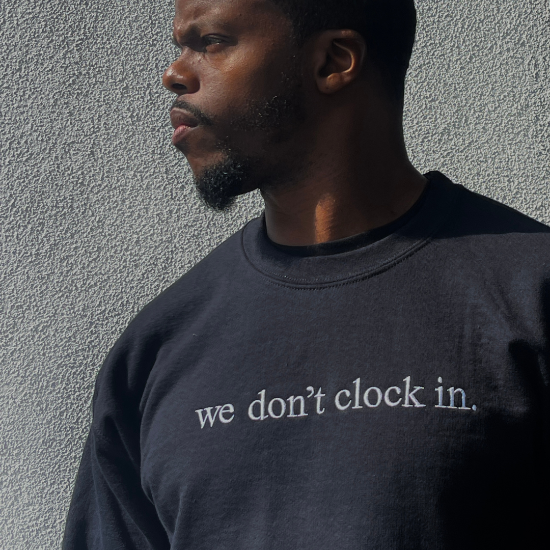 Our "we don't clock in." black crewneck is made from.... This comfortable and stylish crewneck has been crafted for repeat wear and reflects the intersection of timeless fashion and durability. Crafted with care and precision, its minimalist design allows the powerful statement "we don't clock in." to take center stage, making it a conversation starter wherever you go. Wear with pride, knowing that you're not just wearing a garment, but a symbol of independence and self-determination.